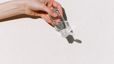 Person Holding Hand Sanitizer