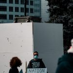 people standing near white concrete building during daytime