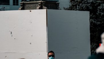 people standing near white concrete building during daytime