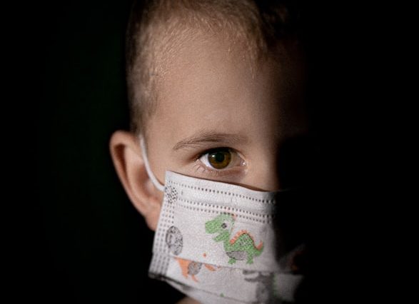 baby with white and green diaper