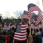 people holding us a flag during daytime